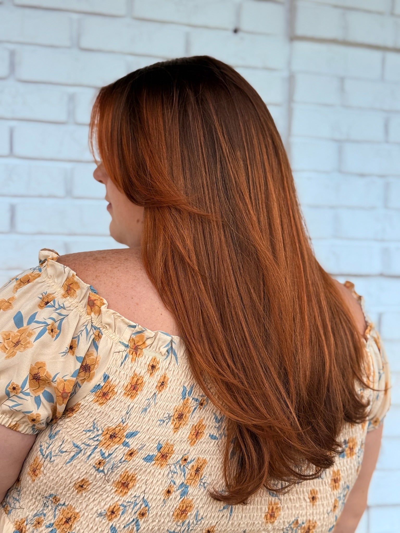 long orange copper hair, mostly straight, slight blowout style 