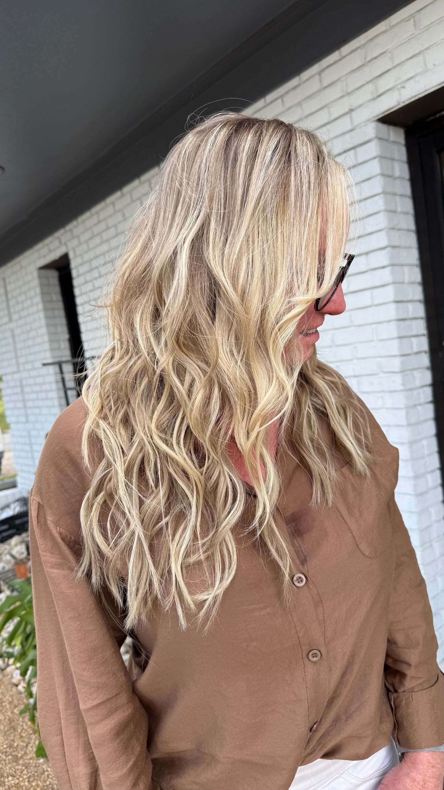 blonde highlights with extensions on beach waved hair