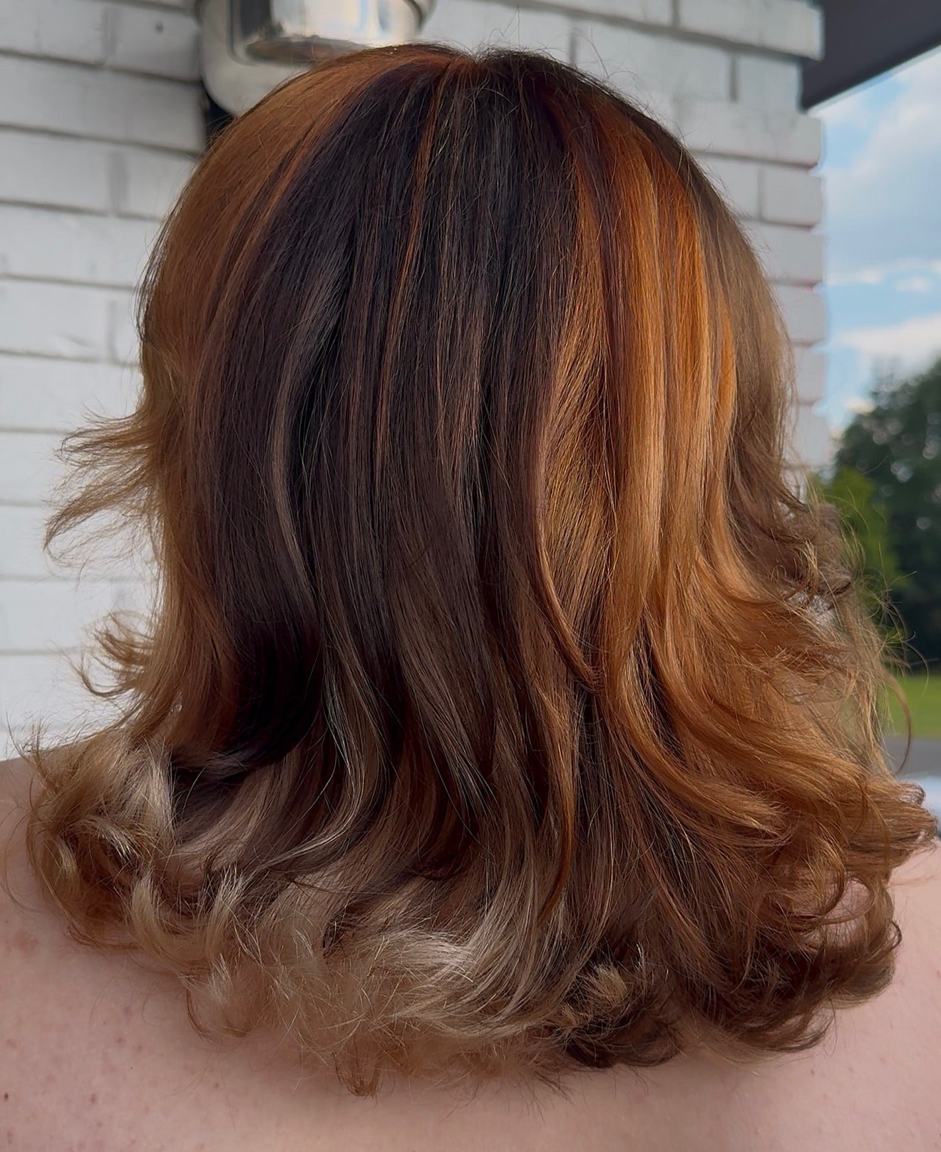 curled calico style hair color with ginger, blonde, and brunette colors