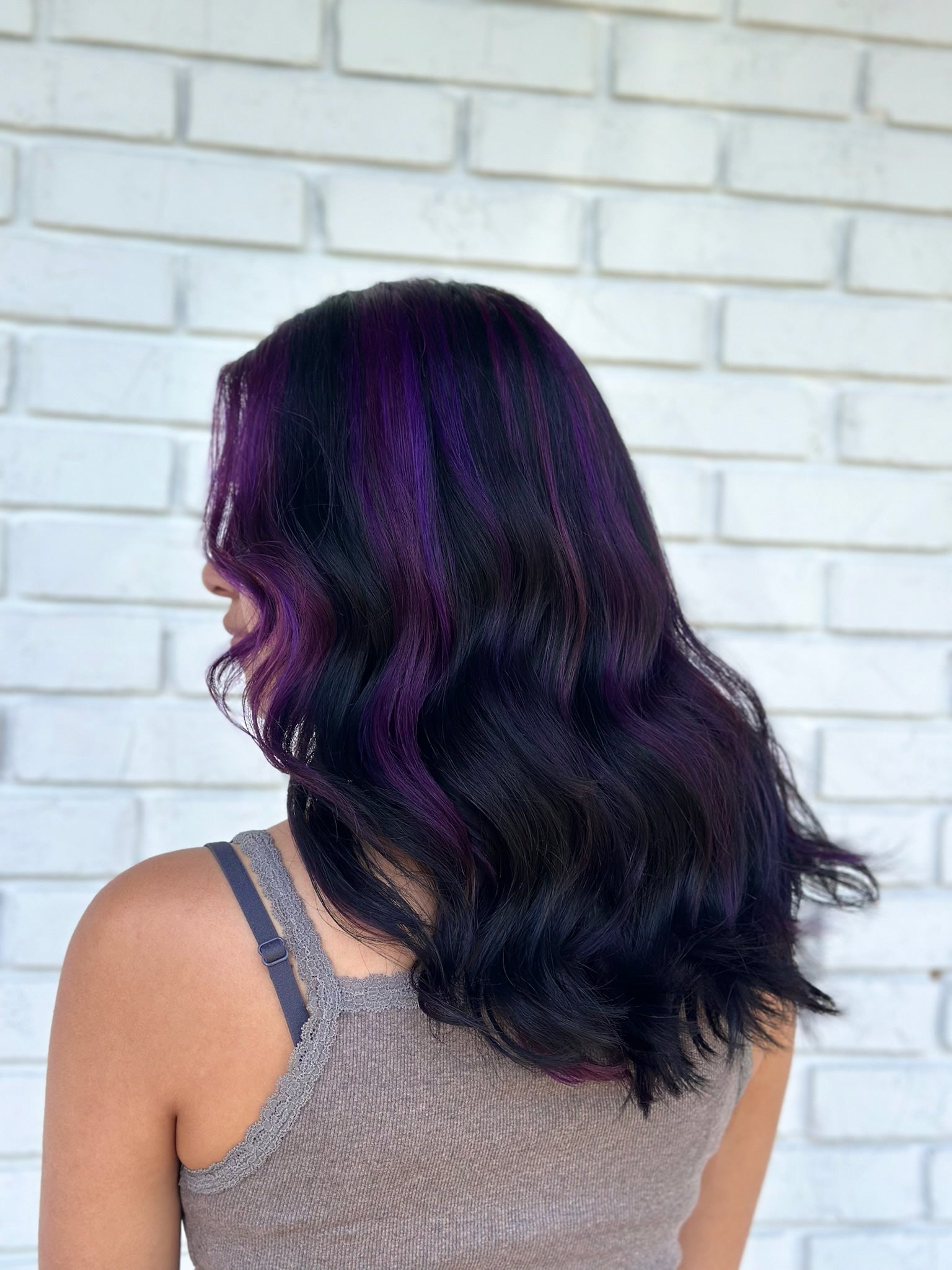 dark rich purple highlights in dark black wavy hair 