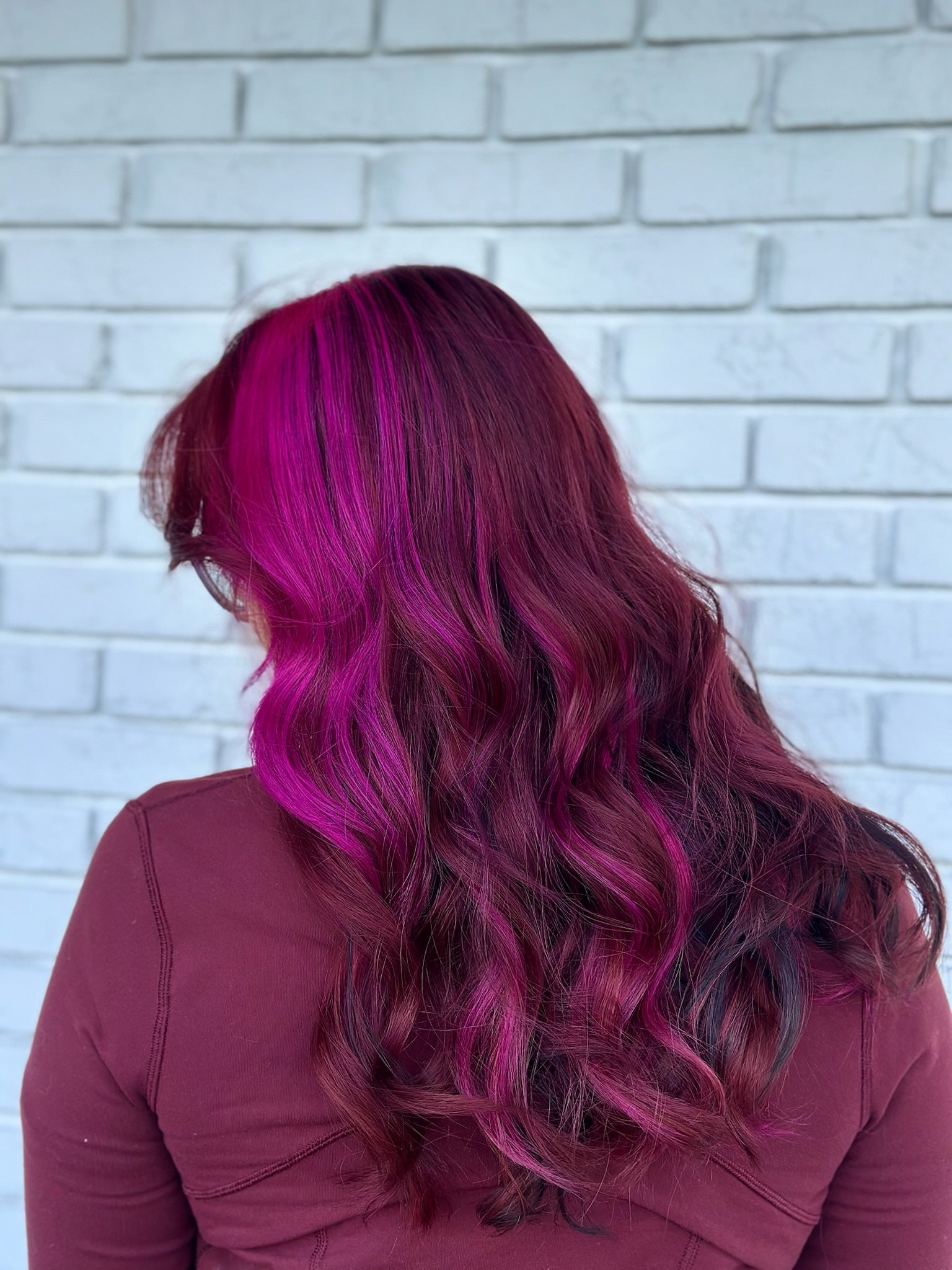 pink magenta highlights with dark black lowlights, wavy hair