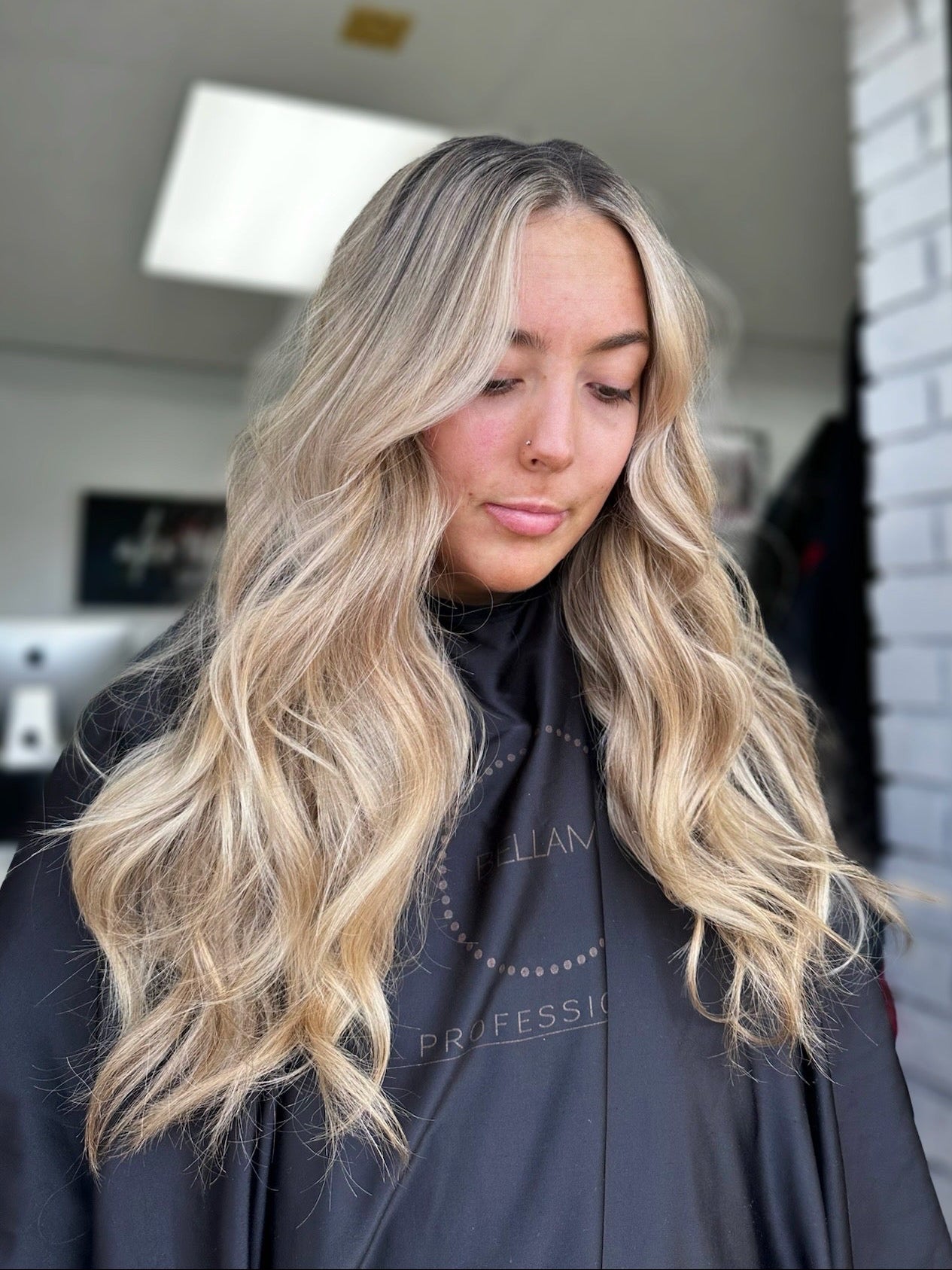 long lived-in blonde highlighted hair that is curled 